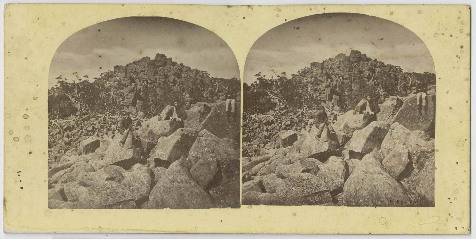 Three men sitting on boulders, kunanyi/Mt. Wellington